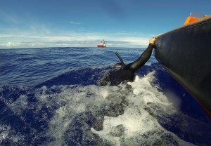 Divers scan the water for debris of the missing Flight MH370